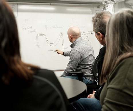 sustainability-landing-page-spotlight-man-whiteboard-writing